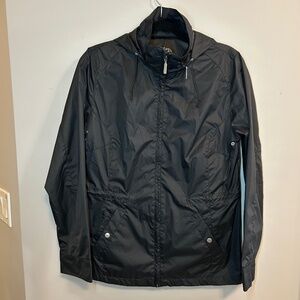 a windbreaker with a hood that folds into a bag with pockets